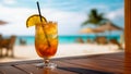 Tropical cocktail in a beautiful glass on a wooden tabletop on a blurred background of a white sand beach with some people