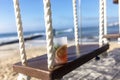 A tropical cocktail drink on a swing overlooking the Caribbean Sea in Mexico\'s Mayan Riviera Royalty Free Stock Photo