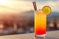 Tropical cocktail of tequila sunrise served with lime and ice at sunset time Royalty Free Stock Photo