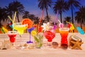 Tropical cocktails on white sand mojito on sunset palm trees Royalty Free Stock Photo