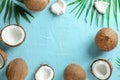 Tropical coconuts with palm branches on color background