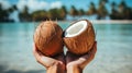 Tropical coconuts in women\'s hands. Royalty Free Stock Photo