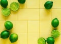 Tropical Culinary Delight: Aromatic Lime Slices and Green Leaves on a Yellow Tile Background, Adding Zest to your Cooking