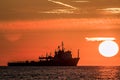 Tropical dawn at sea. Ship at sunrise on the ocean horizon