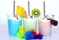 Tropical exotic Fruit smoothies or milkshakes on white background. Blue with pineapple, green with kiwi, pink with cherry. Summer