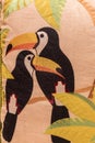 Tropical fabric embroidered background of two toucans