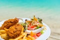 Tropical food of grilled fish, vegetables dish served on tropical island in Aitutaki lagoon, Cook Islands. With selective focus Royalty Free Stock Photo