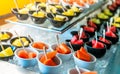 Tropical fruit buffet at event in restaurant. Catering food. Fresh papaya, watermelon and pineapple slices in small bowl on