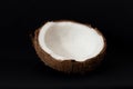 Tropical fruit concept, Halves of fresh white coconut on black background Royalty Free Stock Photo