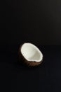 Tropical fruit concept, Halves of fresh white coconut on black background Royalty Free Stock Photo