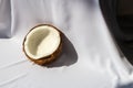 Tropical fruit concept, Halves of fresh white coconut on white fabric background Royalty Free Stock Photo