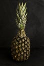 Isolated pineapple, over black stone background