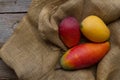 Tropical fruit mango on old vintage cloth and wooden background