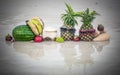 Tropical fruit mix on beach. Pineapple with sunglasses water reflection Royalty Free Stock Photo