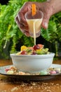 Pouring yogurt on fruit salad Royalty Free Stock Photo