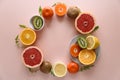 Tropical fruits frame from orange, lemon, tangerine and kiwi on pink paper background. Healthy food concept. flat lay. Top view Royalty Free Stock Photo