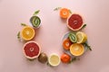Tropical fruits frame from orange, lemon, tangerine and kiwi on pink paper background. Healthy food concept. flat lay. Top view Royalty Free Stock Photo