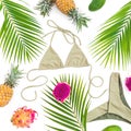 Tropical fruits with palm leaves and bikini swimwear on white background. Flat lay Royalty Free Stock Photo