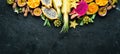 Tropical fruits - passion fruit, pineapple, dragon fruit, kiwi and cactus on a black background. Top view. Royalty Free Stock Photo