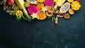 Tropical fruits - passion fruit, pineapple, dragon fruit, kiwi and cactus on a black background. Top view. Royalty Free Stock Photo