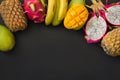 Tropical fruits pineapple, banana, dragon fruit and mango on black. Top view. Royalty Free Stock Photo