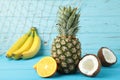 Tropical fruits. Pineapple, coconut, orange and banana on blue background Royalty Free Stock Photo