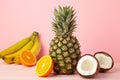 Tropical fruits. Pineapple, coconut, orange and banana on pink background Royalty Free Stock Photo