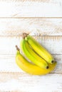 Tropical Fruits Ripe Yellow and Green Bananas on White Planked Wood Background. Healthy Diet Vitamins