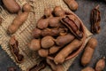 Tropical fruits, Tamarindo beans in shell on a brown butchers block on a dark background, healthy fruit. banner, menu, recipe Royalty Free Stock Photo