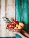 Tropical fruits in a wicker basket. Pineapple, mango, dragon fruit. Royalty Free Stock Photo