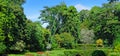 Tropical garden with many flowers and exotic trees. Wide photo Royalty Free Stock Photo