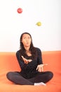 Tropical girl juggling with apple and pear Royalty Free Stock Photo