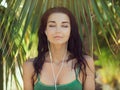 Tropical girl listening to music on earphones Royalty Free Stock Photo
