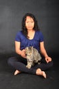 Tropical girl with tabby cat on lap Royalty Free Stock Photo