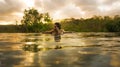 Tropical holidays lifestyle portrait of young beautiful and happy Asian Korean woman in bikini enjoying sunset at amazing jungle