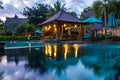 Tropical hotel with swimming pool at night with reflections and palms, Gili Trawangan, Lombok, Indonesia Royalty Free Stock Photo