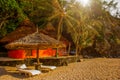 Tropical house, beach chair and umbrella on the beach Royalty Free Stock Photo