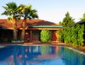 tropical house with palms and swimming pool