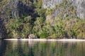 Tropical hut on seacoast. Bamboo cabin on sand beach under palm trees. Ecotourism concept. Royalty Free Stock Photo