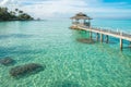 Tropical hut and wooden bridge at holiday resort. Summer travel Royalty Free Stock Photo