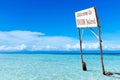 Billboard in middle of tropical lagoon.