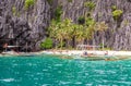 Tropical island landscape with bangca traditional philippines boats anchored at the shore, Palawan