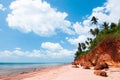 Tropical island red cliff rock beach with blue sky and clouds in summer, tranquil serene ocean scenery. Fang Daeng in Prachuap