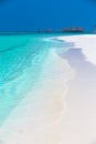 Tropical island with sandy beach, palm trees, overwater bungalow Royalty Free Stock Photo