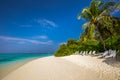 Tropical island with sandy beach, palm trees, overwater bungalow Royalty Free Stock Photo