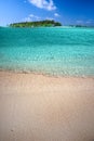 Tropical island with sandy beach, palm trees, overwater bungalow Royalty Free Stock Photo