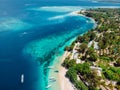 Tropical island with village, beach and turquoise crystal ocean, aerial view Royalty Free Stock Photo