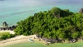 Tropical island with a white beach and limestone cliffs, aerial view. Sabitang Laya