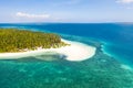 Tropical island of white sand with coconut trees. Boat with tourists on a beautiful beach, aerial view Royalty Free Stock Photo