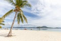 Tropical island with white sand, palm tree and boats